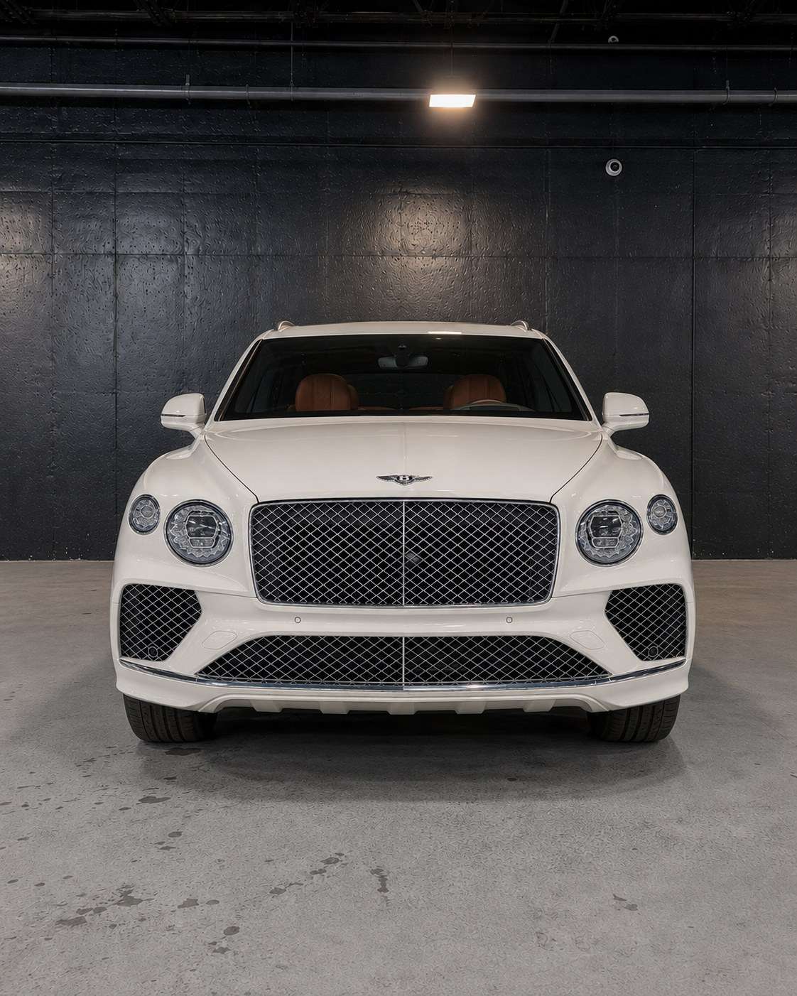 White Bentley Bentayga, straight front in the studio