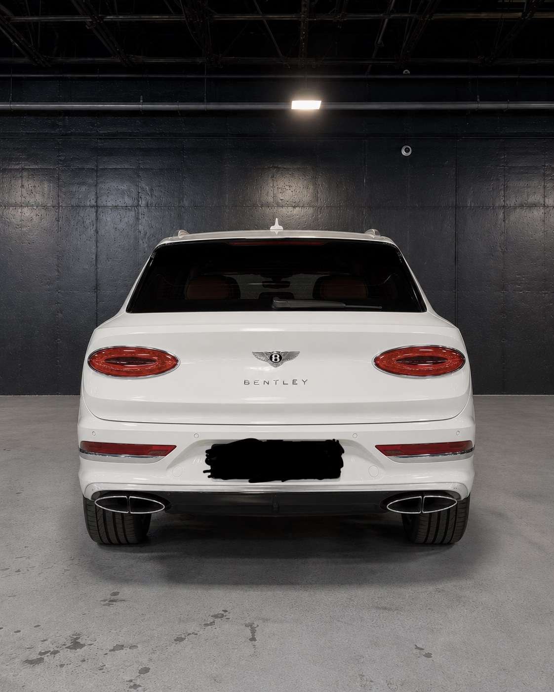 White Bentley Bentayga, straight rear in the studio