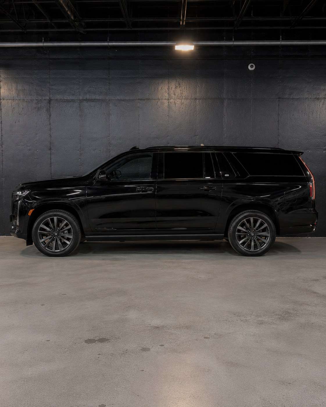 Black Cadillac Escalade ESV, full side profile in the studio showing the extended wheelbase