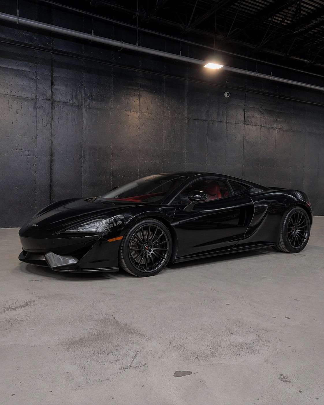 Black McLaren 570GT, front three quarter in the studio