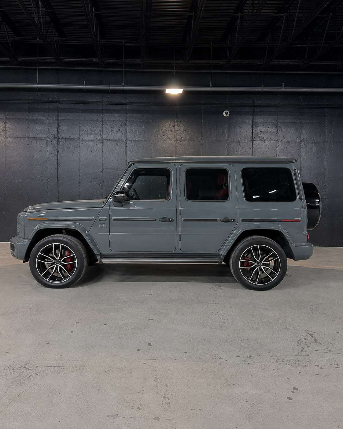 Grey Mercedes-AMG G63, side profile in the studio