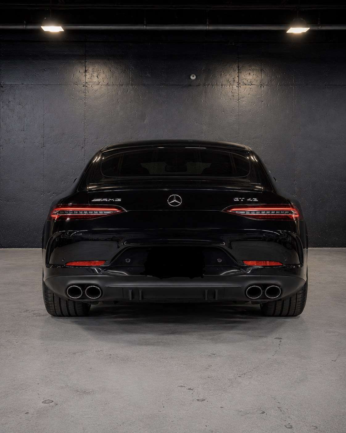 Black Mercedes-AMG GT 43, straight rear view with the GT 43 badge and quad exhaust tips