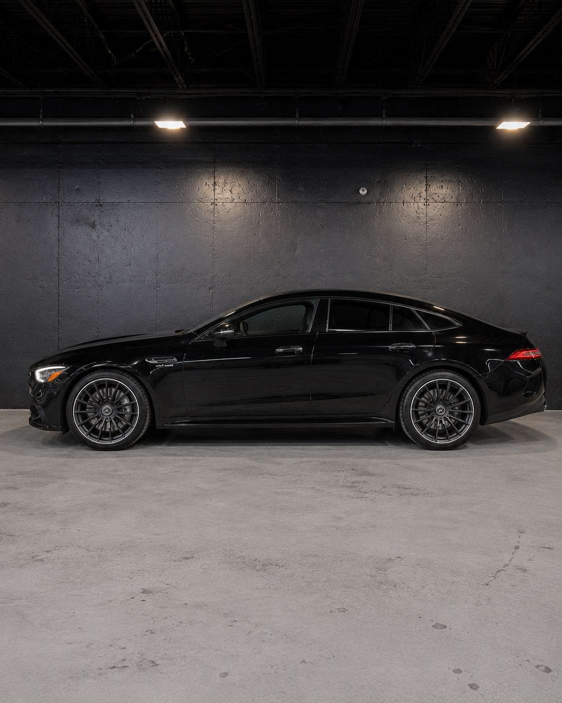 Black Mercedes-AMG GT 43, full side profile in the studio