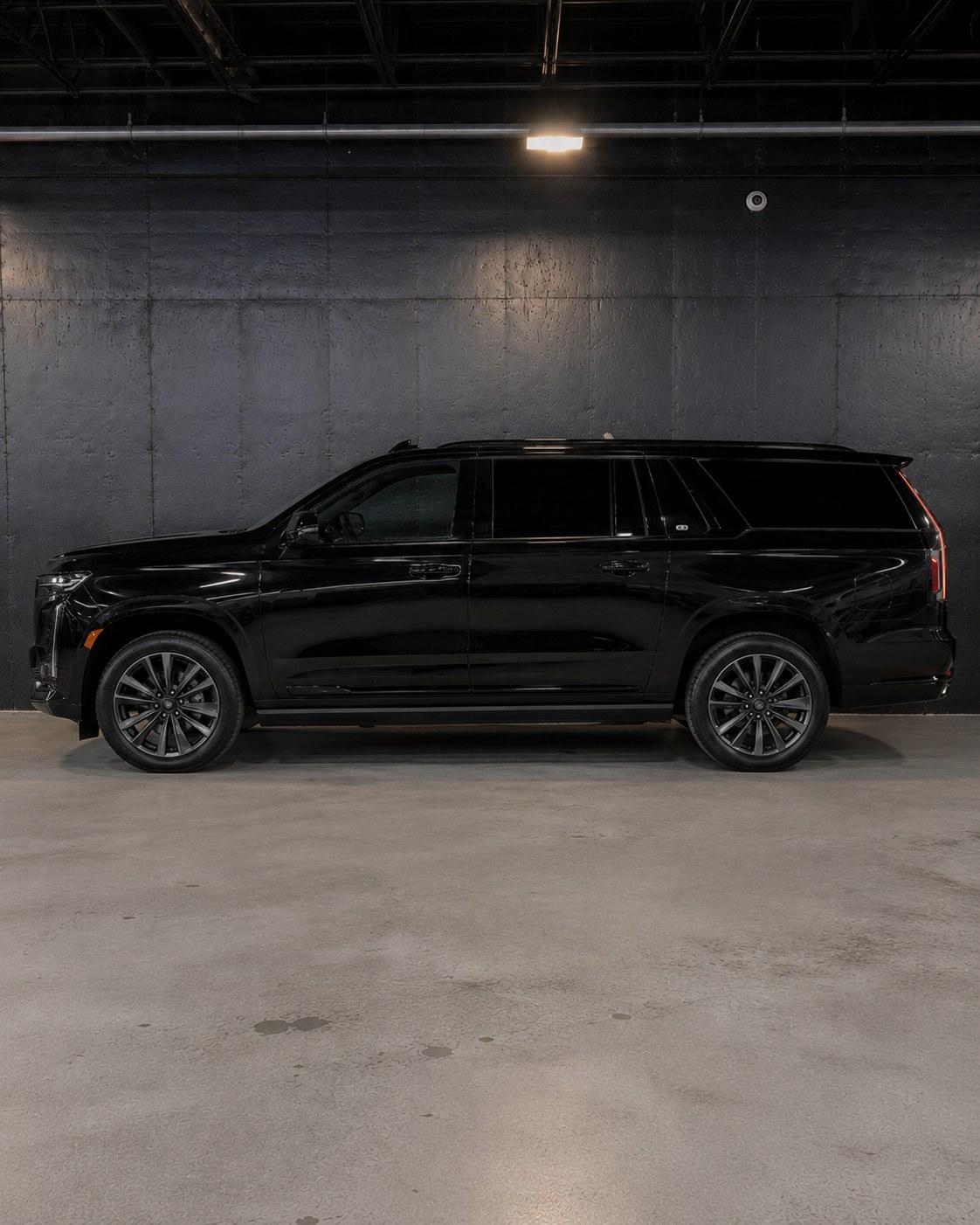 Black Cadillac Escalade ESV, full side profile in the studio showing the extended wheelbase