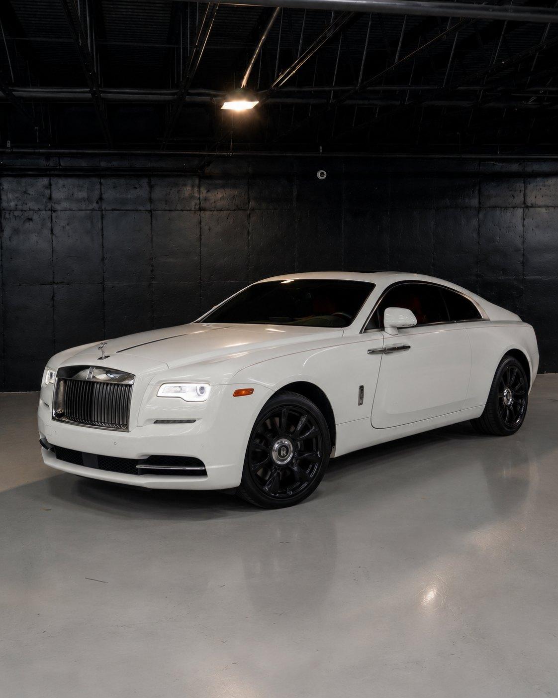 White Rolls-Royce Wraith with red interior, front three quarter in a dark studio