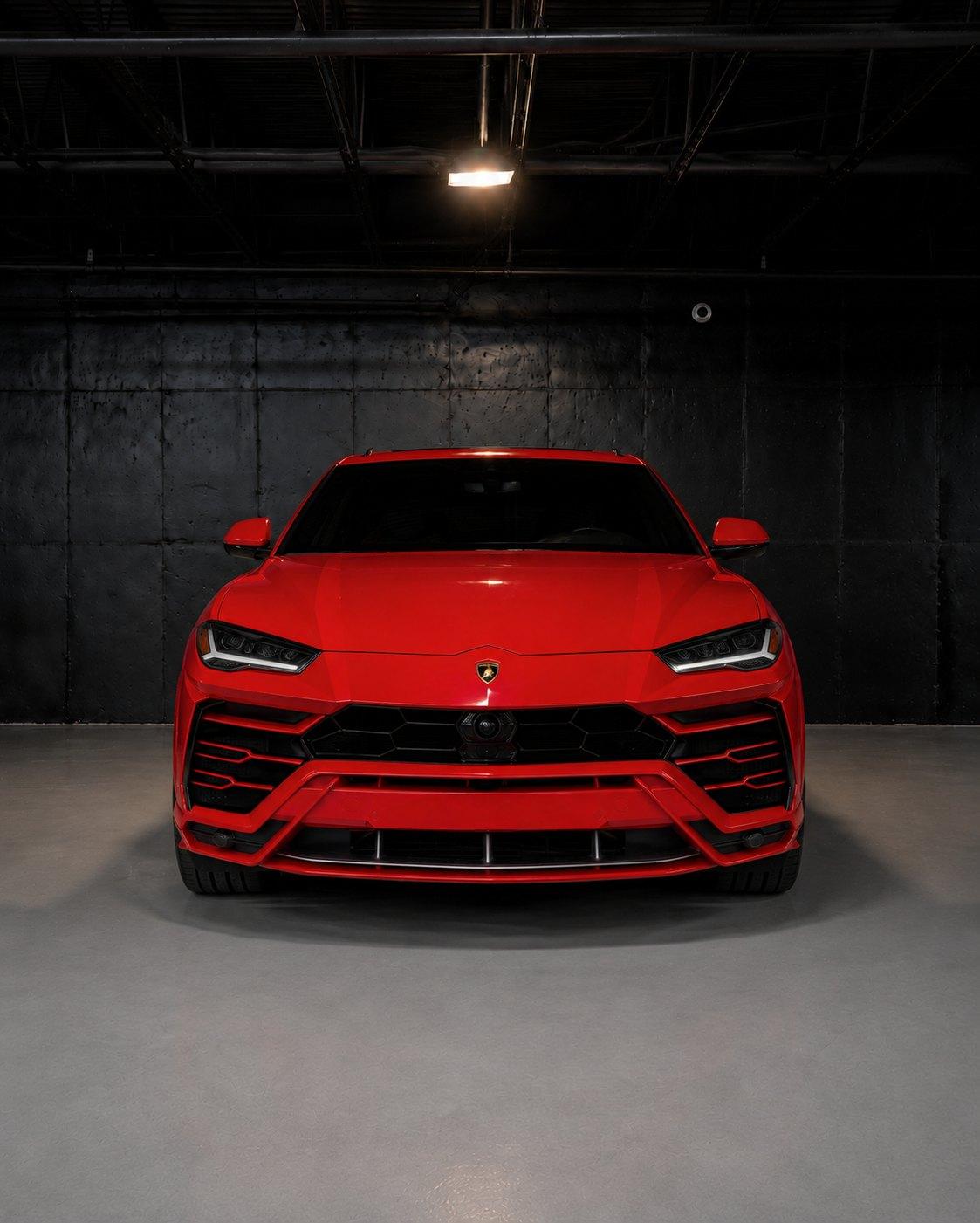 Red Lamborghini Urus, straight front view in the studio