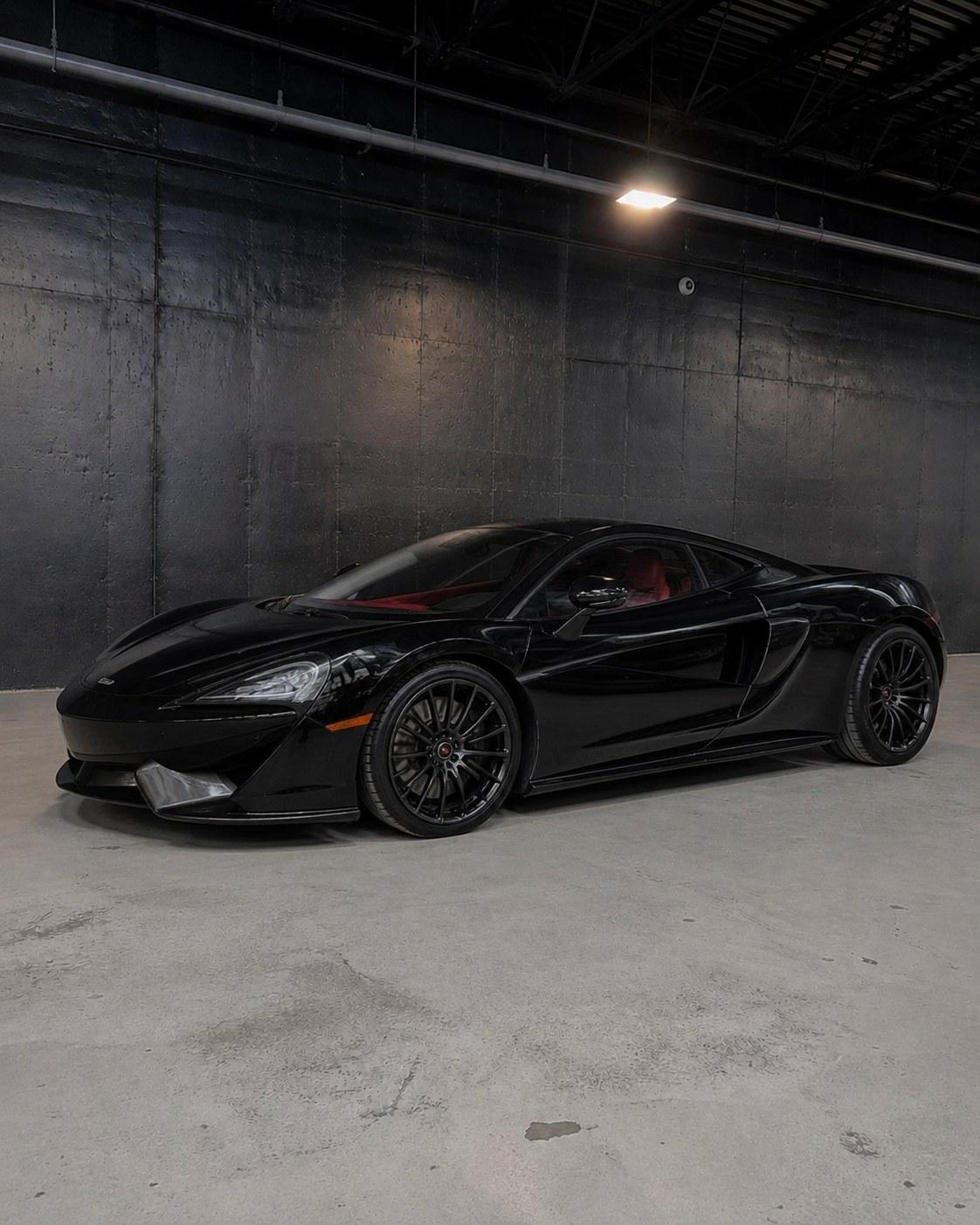 Black McLaren 570GT, front three quarter in the studio