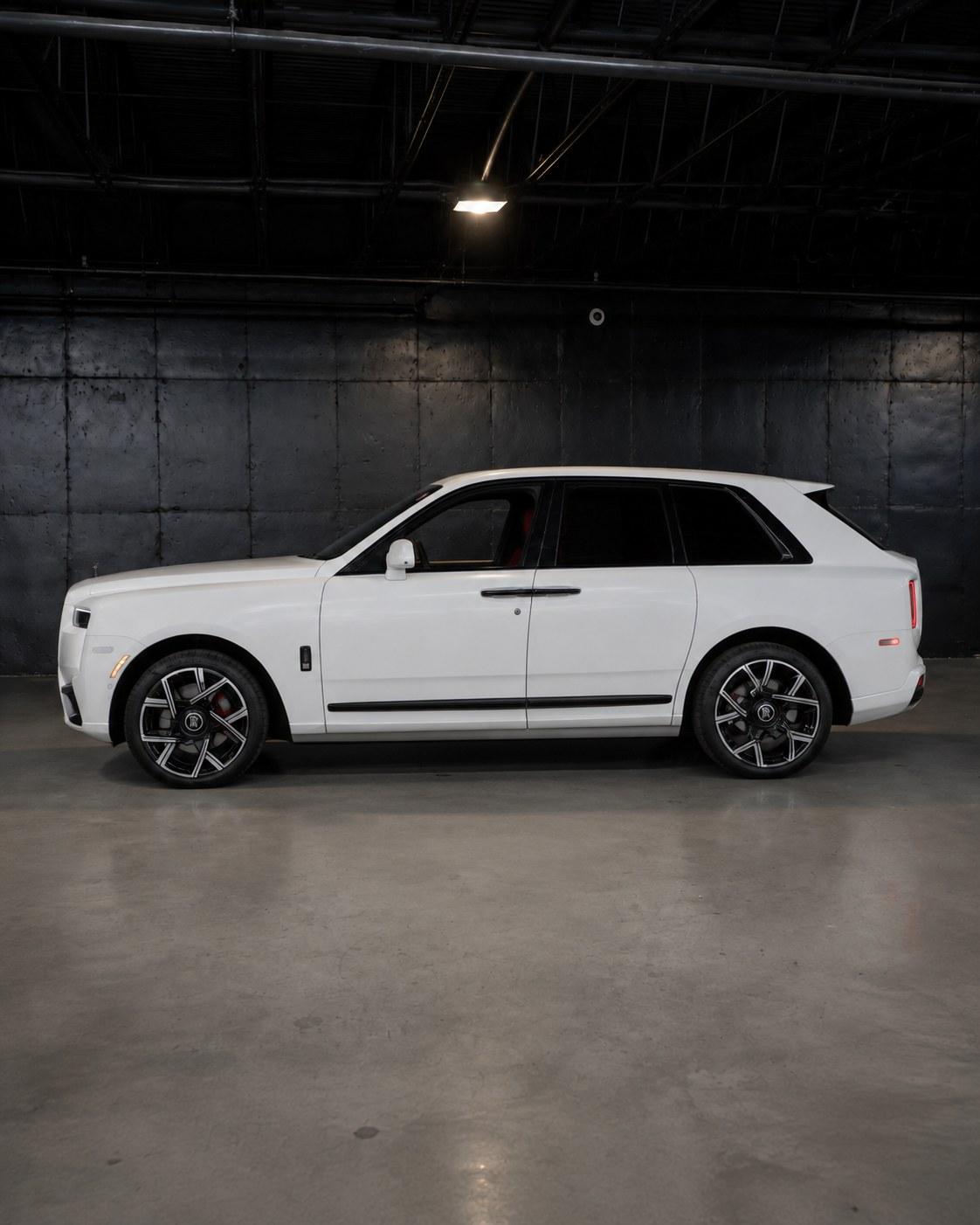 White Rolls-Royce Cullinan Black Badge, side profile in the studio